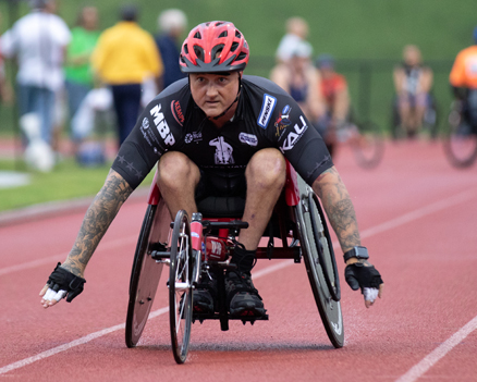 image disabled man racing in a wheelchair